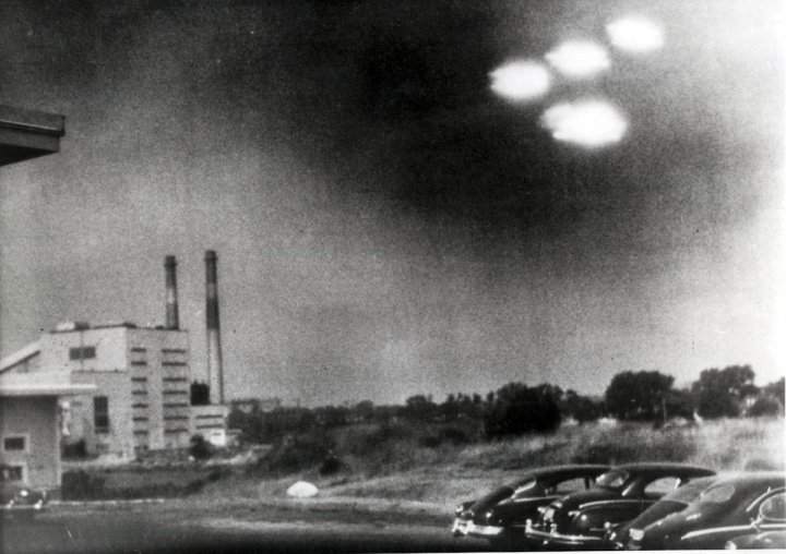 Salem, Massachusetts, USA. 3rd August, 1952. This picture, taken through the window of a laboratory by a 21 year old U.S. coastguard, shows four unidentified flying objects as bright lights in the sky. Many American's believe them to be flying saucers.